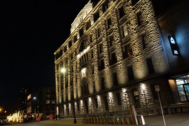 Stone building facade grazed with uplights at night
